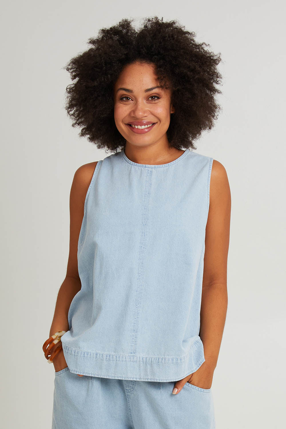 Model Olivia wearing size S of the Playa Cotton Tank in colour Capri (Blue), from the front, cropped image