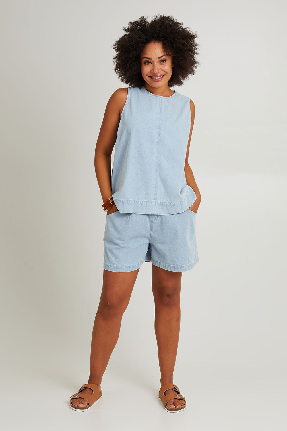 Model Olivia wearing size S of the Playa Cotton Tank in colour Capri (Blue), from the front, showing the whole outfit