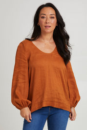 Model Katie wearing size S of the Nama Top in colour Ochre, from the front, cropped image