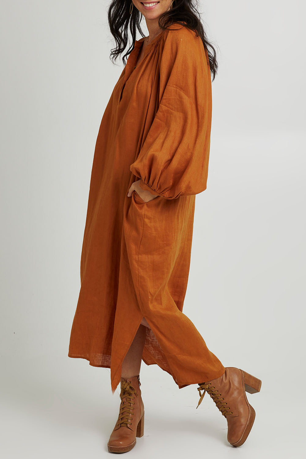 Model Katie wearing size S of the Nama Dress in colour Ochre, from the front, cropped image