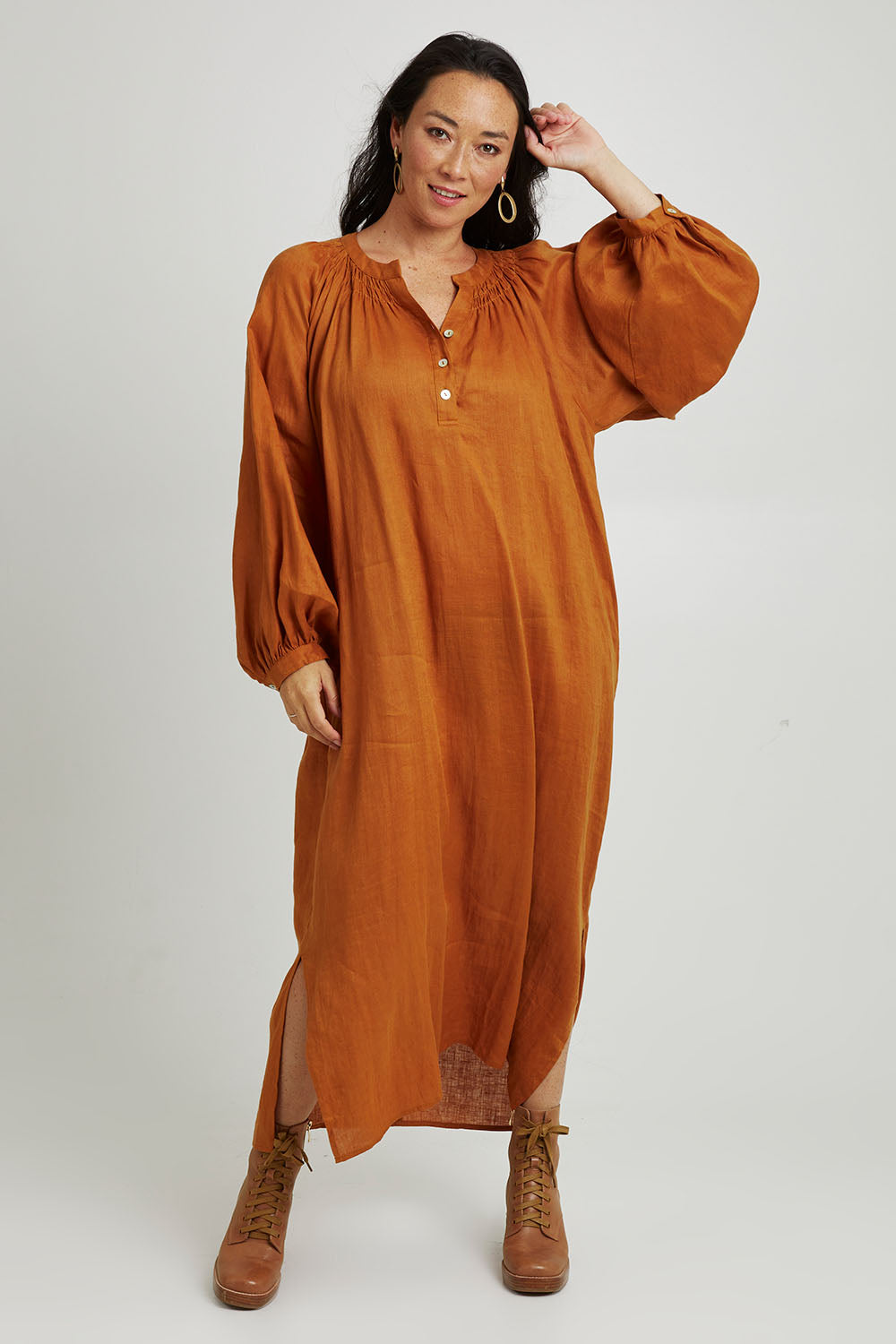 Model Katie wearing size S of the Nama Dress in colour Ochre, from the front, showing the whole outfit