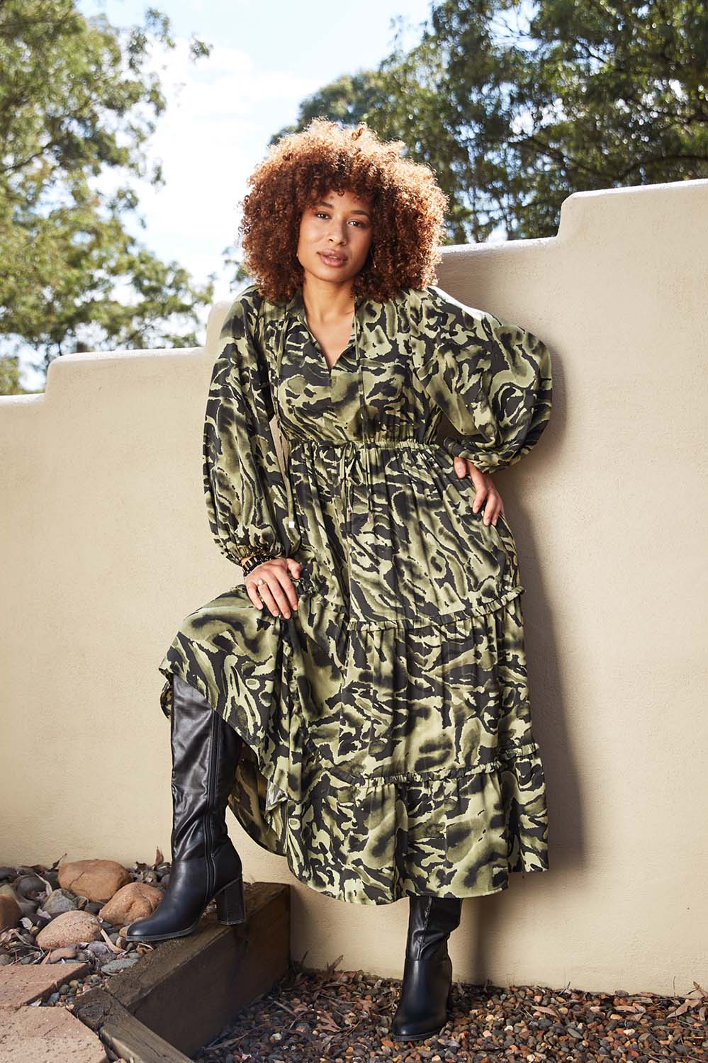 A model wearing the Mayan Tiered Maxi in colour Fern (Green), from the front, showing the whole outfit