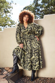 A model wearing the Mayan Tiered Maxi in colour Fern (Green), from the front, showing the whole outfit
