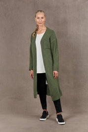A model wearing the Paarl Longline Cardigan in colour Moss (Green), from the front, showing the whole outfit