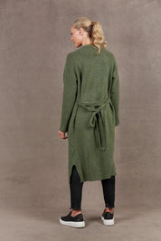 A model wearing the Paarl Longline Cardigan in colour Moss (Green), from the front, showing the whole outfit