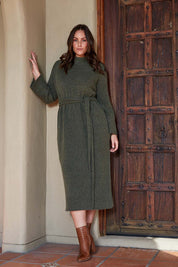 A model wearing the Paarl Tie Knit Dress in colour Moss (Green), from the front, showing the whole outfit