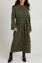 Model Katie wearing size OneSize of the Paarl Tie Knit Dress in colour Moss (Green), from the front, cropped image