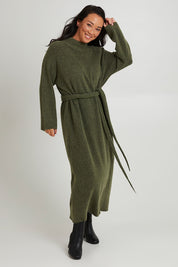 Model Katie wearing size OneSize of the Paarl Tie Knit Dress in colour Moss (Green), from the front, showing the whole outfit