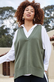 A model wearing the Nakako Vest in colour Moss (Green), from the front, showing the whole outfit