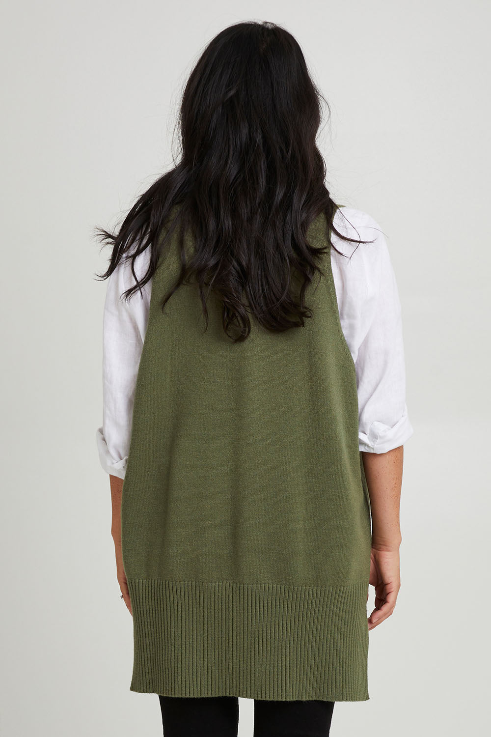Model Katie wearing size S of the Nakako Vest in colour Moss (Green), from the back