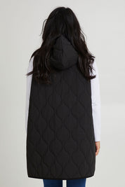 Model Katie wearing size S of the Ribe Vest in colour Ebony (Black), from the back
