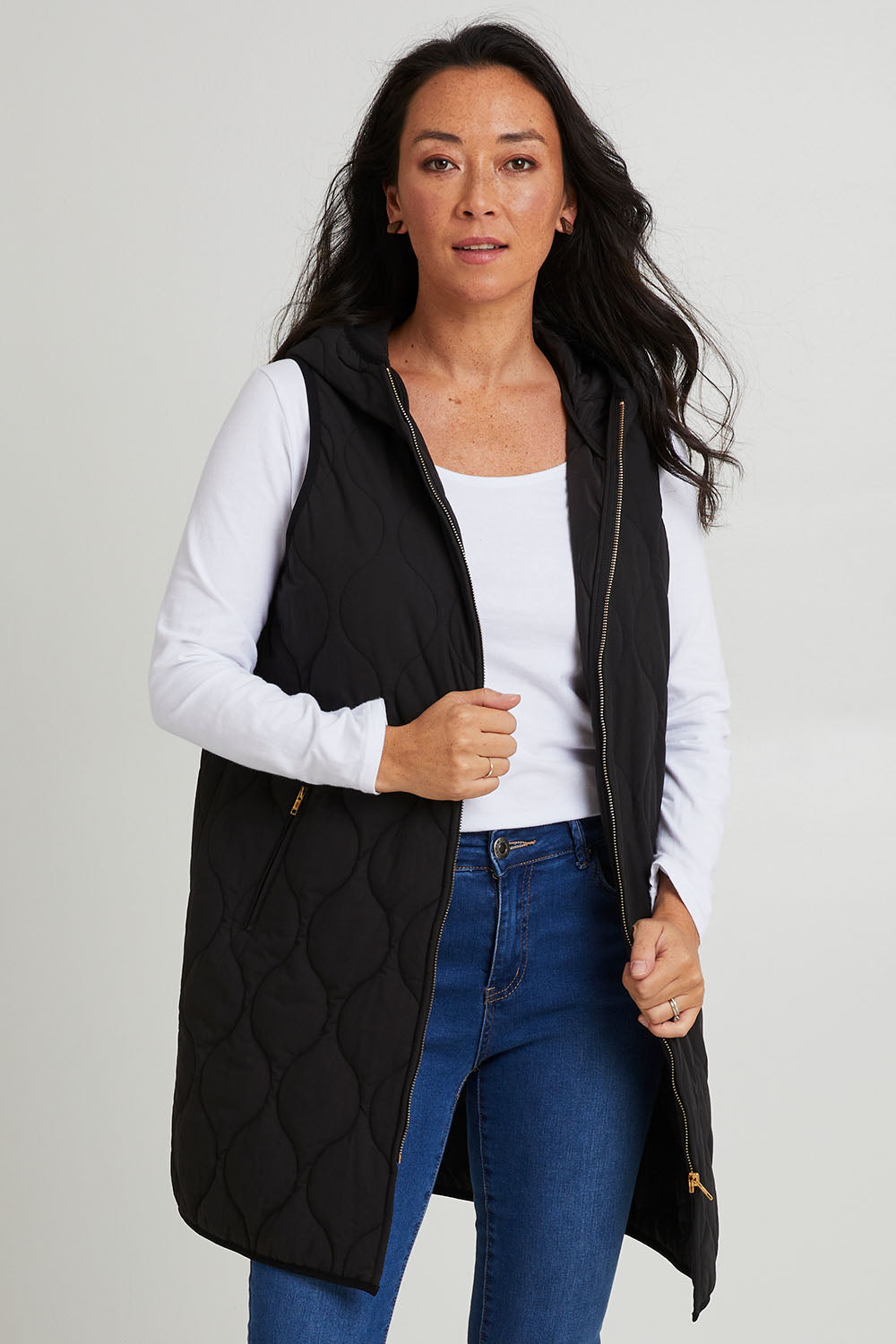Model Katie wearing size S of the Ribe Vest in colour Ebony (Black), from the front, cropped image