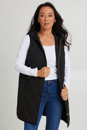Model Katie wearing size S of the Ribe Vest in colour Ebony (Black), from the front, cropped image