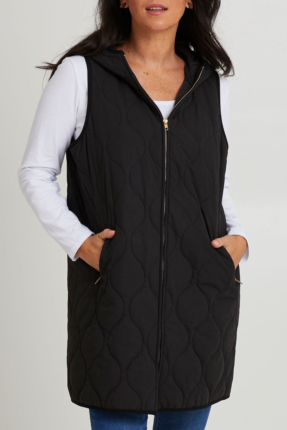 Model Katie wearing size S of the Ribe Vest in colour Ebony (Black), from the front, cropped image