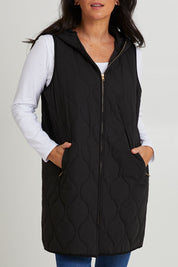 Model Katie wearing size S of the Ribe Vest in colour Ebony (Black), from the front, cropped image