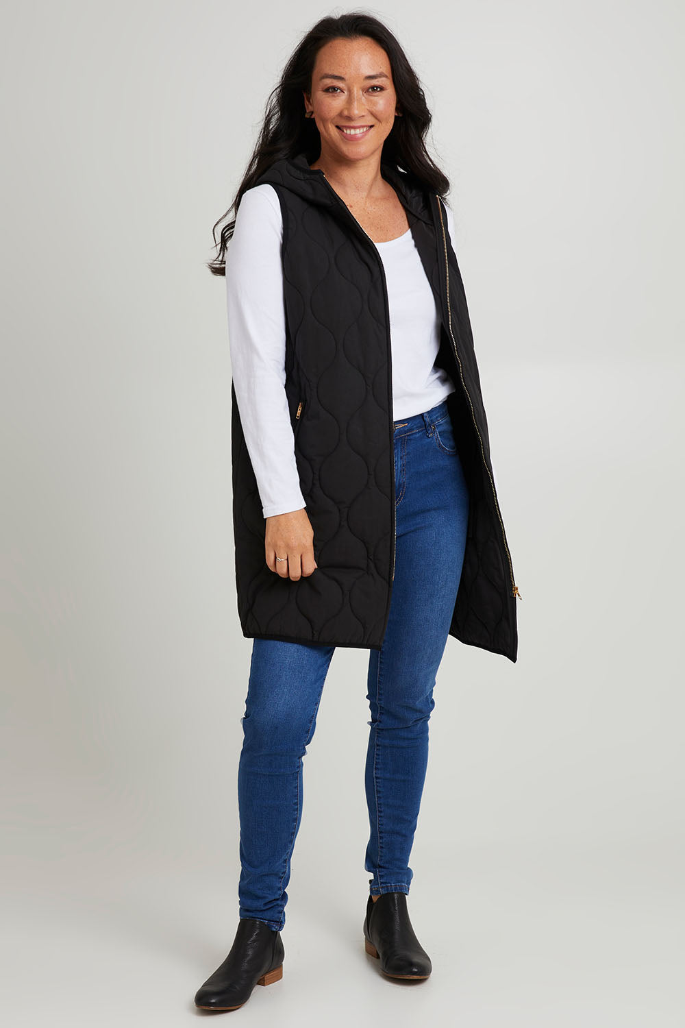 Model Katie wearing size S of the Ribe Vest in colour Ebony (Black), from the front, showing the whole outfit