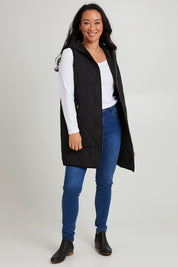 Model Katie wearing size S of the Ribe Vest in colour Ebony (Black), from the front, showing the whole outfit