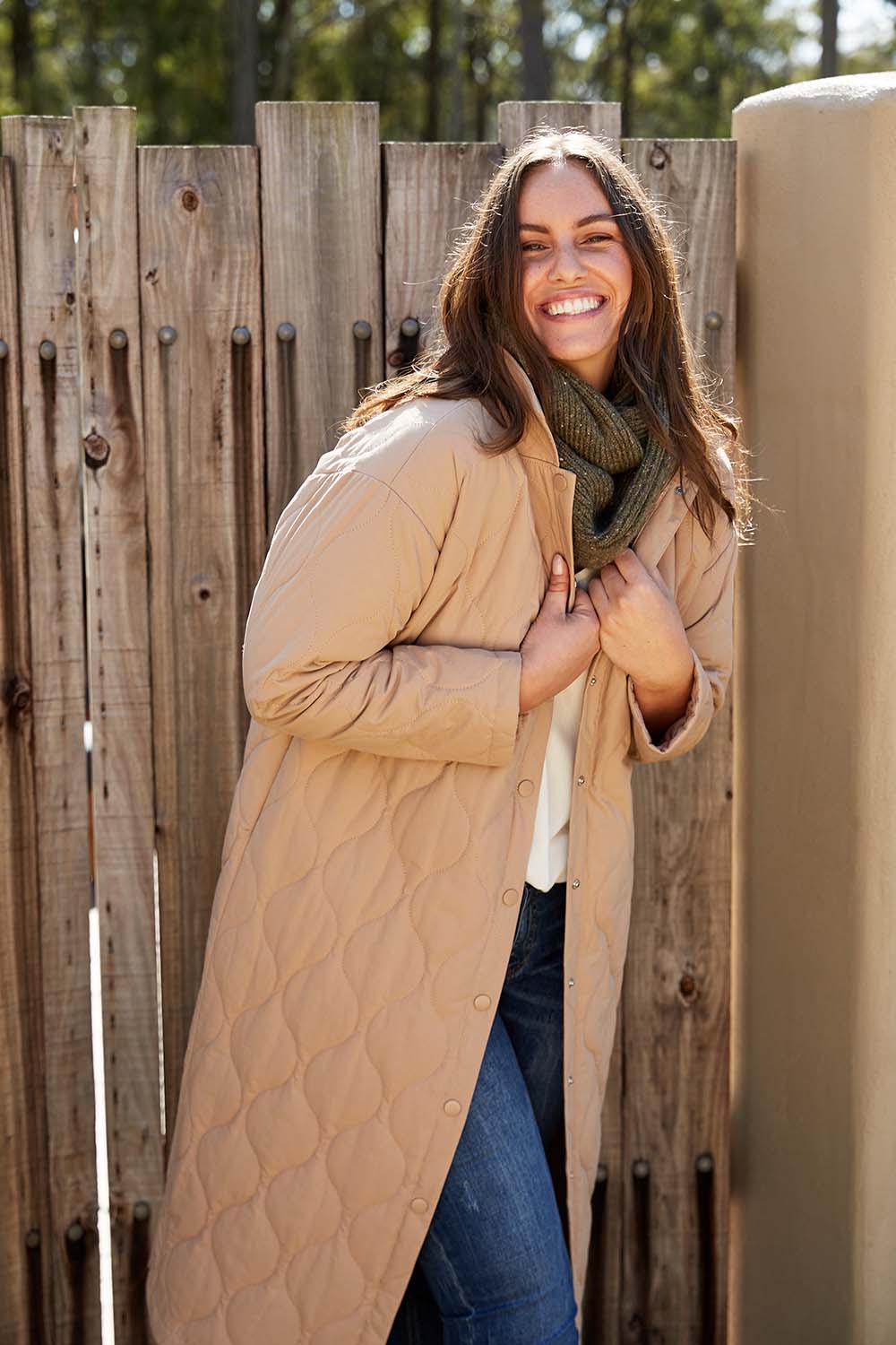 A model wearing the Ribe Coat in colour Putty, from the front, showing the whole outfit