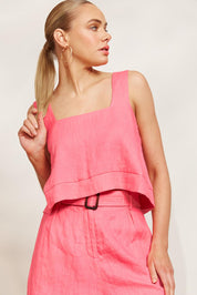 A model wearing the Halcyon Linen Tank in colour Musk (Pink), from the front, showing the whole outfit