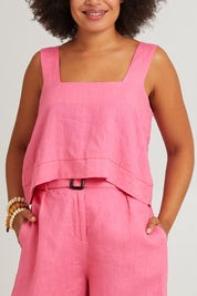 Model Olivia wearing size S of the Halcyon Linen Tank in colour Musk (Pink), from the front, cropped image