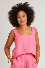 Model Olivia wearing size S of the Halcyon Linen Tank in colour Musk (Pink), from the front, cropped image