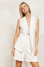 A model wearing the Halcyon Linen Shorts in colour Opal (White), from the front, showing the whole outfit
