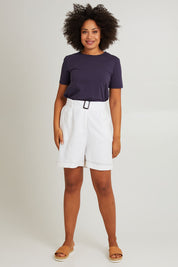 Model Olivia wearing size S of the Halcyon Linen Shorts in colour Opal (White), from the front, showing the whole outfit