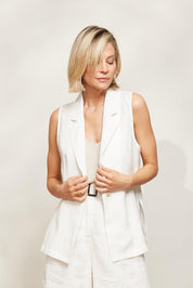 A model wearing the Halcyon Linen Vest in colour Opal (White), from the front, showing the whole outfit