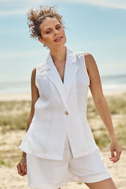 Model Lala wearing size S of the Halcyon Linen Vest in colour Opal (White), from the front, showing the whole outfit
