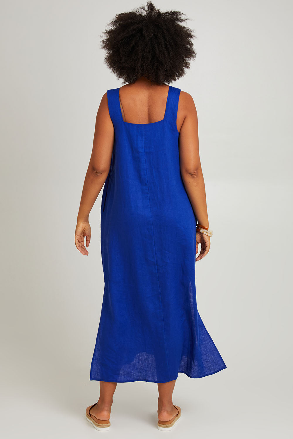 Model Olivia wearing size S of the Halcyon Linen Tank Dress in colour Cobalt (Blue), from the back