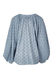 Product shot of the Zephyr Blouse in colour Nevada (Blue), from the back
