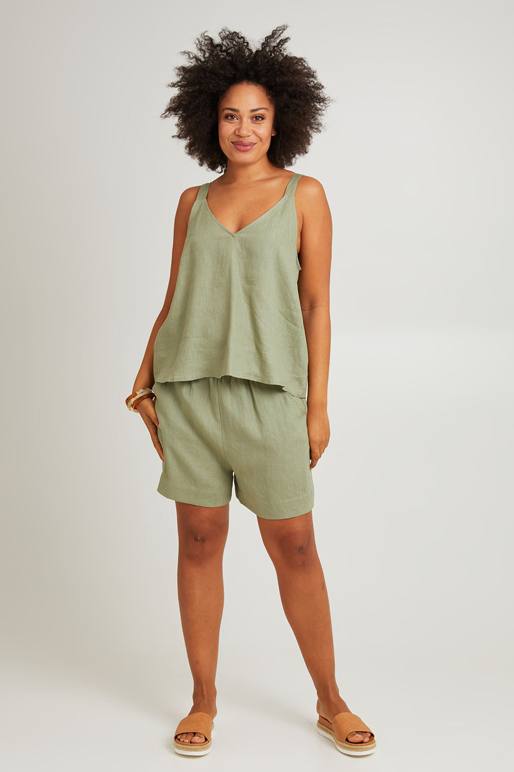Model Olivia wearing size S of the Sojourn Linen Tank in colour Aloe (Green), from the front, showing the whole outfit