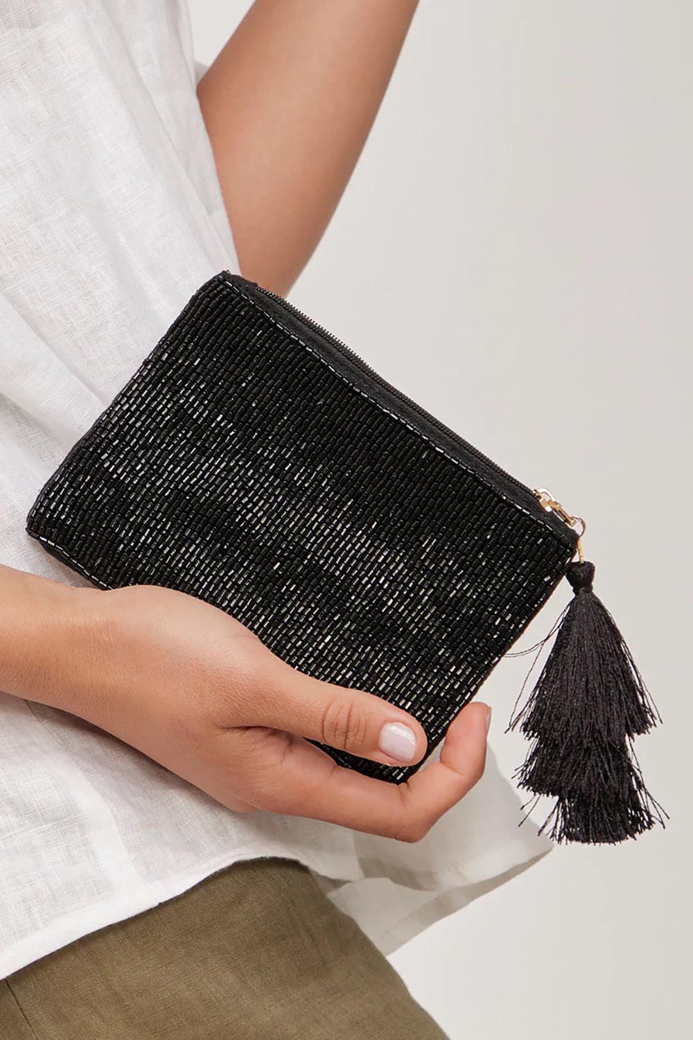 A model wearing the Playa Beaded Pouch in colour Black (Black), from the front, showing the whole outfit
