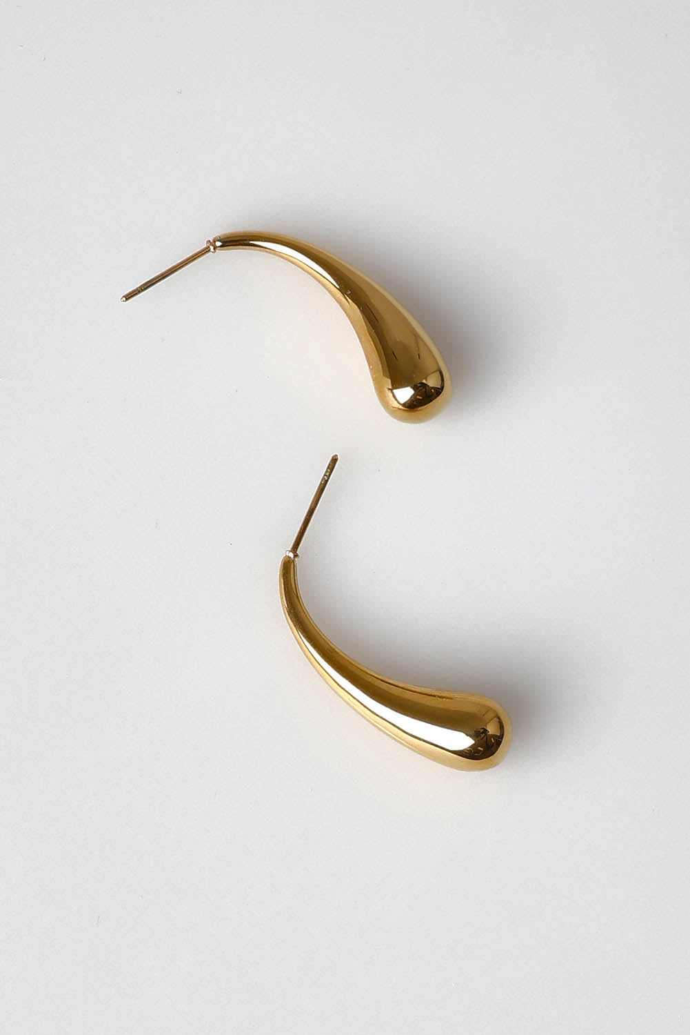 A model wearing the Halcyon Drop Earring in colour Gold (Metallics), from the front, showing the whole outfit