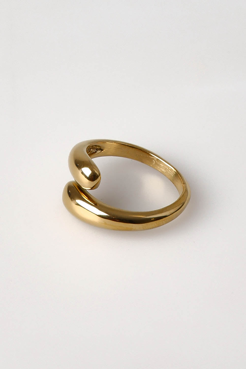 A model wearing the Halcyon Wrap Ring in colour Gold (Metallics), from the front, showing the whole outfit