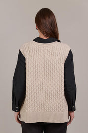 A model wearing the Naviva Cotton Vest in colour Oat, from the back