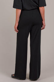 A model wearing the Palmer Knit Pant in colour Black (Black), from the back
