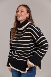 A model wearing the Katana Roll Neck Knit in colour Black (Black), from the front, cropped image