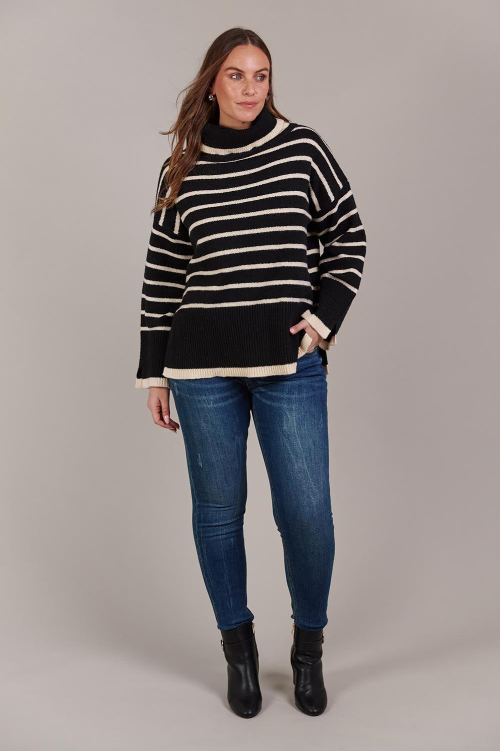 A model wearing the Katana Roll Neck Knit in colour Black (Black), from the front, showing the whole outfit