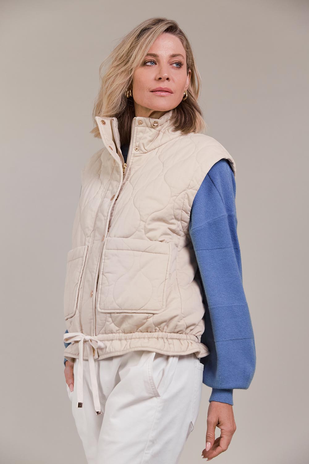 A model wearing the Pepi Cotton Vest in colour Ecru, from the front, cropped image