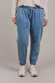 A model wearing the Pepi Relaxed Denim Pant in colour Denim (Blue), from the front, cropped image