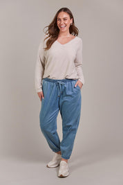 A model wearing the Pepi Relaxed Denim Pant in colour Denim (Blue), from the front, showing the whole outfit