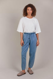 A model wearing the Pepi Relaxed Denim Pant in colour Denim (Blue), from the front, showing the whole outfit