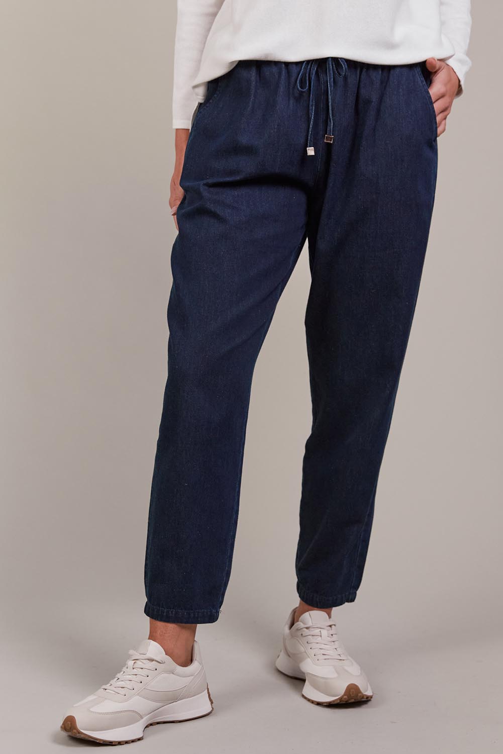 A model wearing the Pepi Relaxed Denim Pant in colour Oxford (Blue), from the front, cropped image