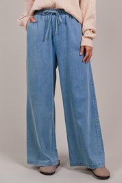 A model wearing the Pepi Wide Leg Denim Pant in colour Denim (Blue), from the front, cropped image