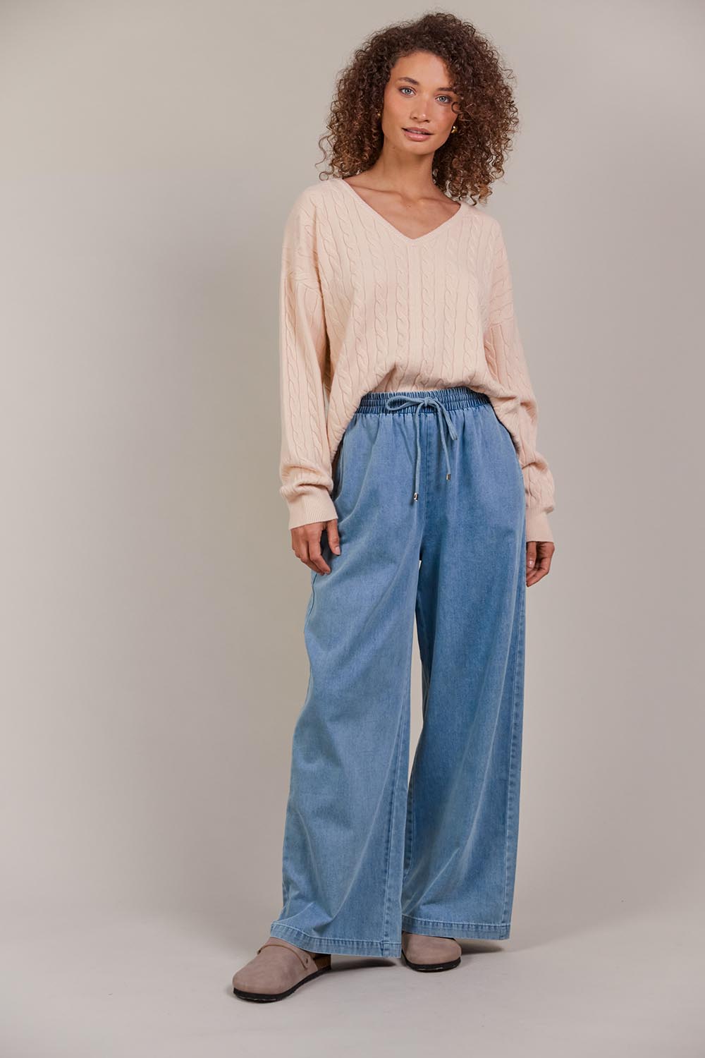 A model wearing the Pepi Wide Leg Denim Pant in colour Denim (Blue), from the front, showing the whole outfit