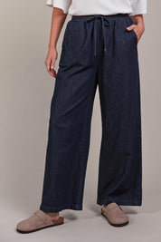 A model wearing the Pepi Wide Leg Denim Pant in colour Oxford (Blue), from the front, cropped image