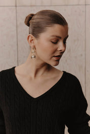 A model wearing the Laax Pearl Drop Earring in colour Gold (Metallics), from the front, showing the whole outfit