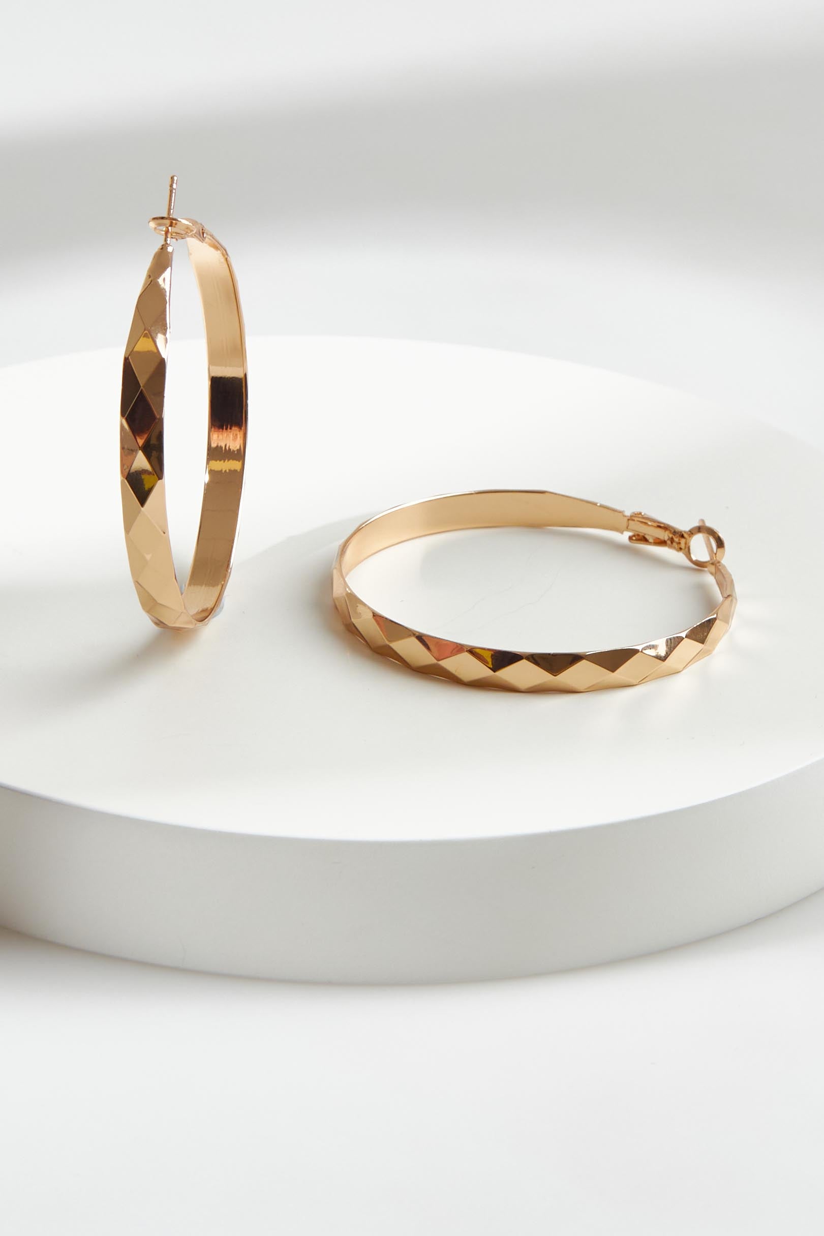 A model wearing the Estel Pressed Hoop Earring in colour Gold (Metallics), from the front, showing the whole outfit
