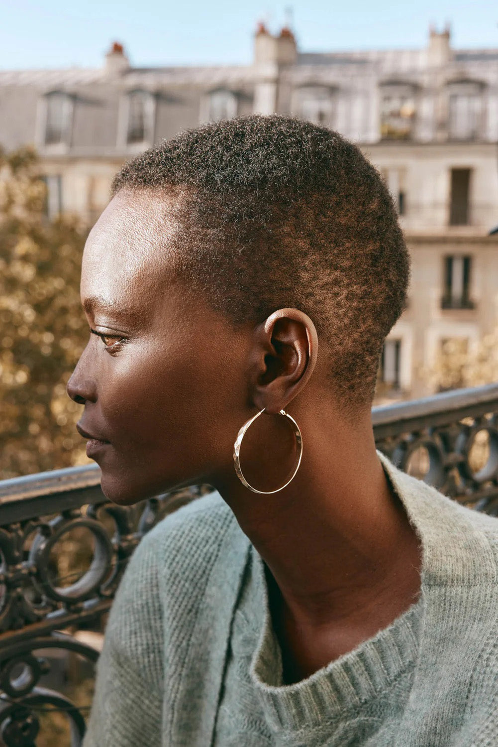 A model wearing the Estel Pressed Hoop Earring in colour Gold (Metallics), from the front, showing the whole outfit